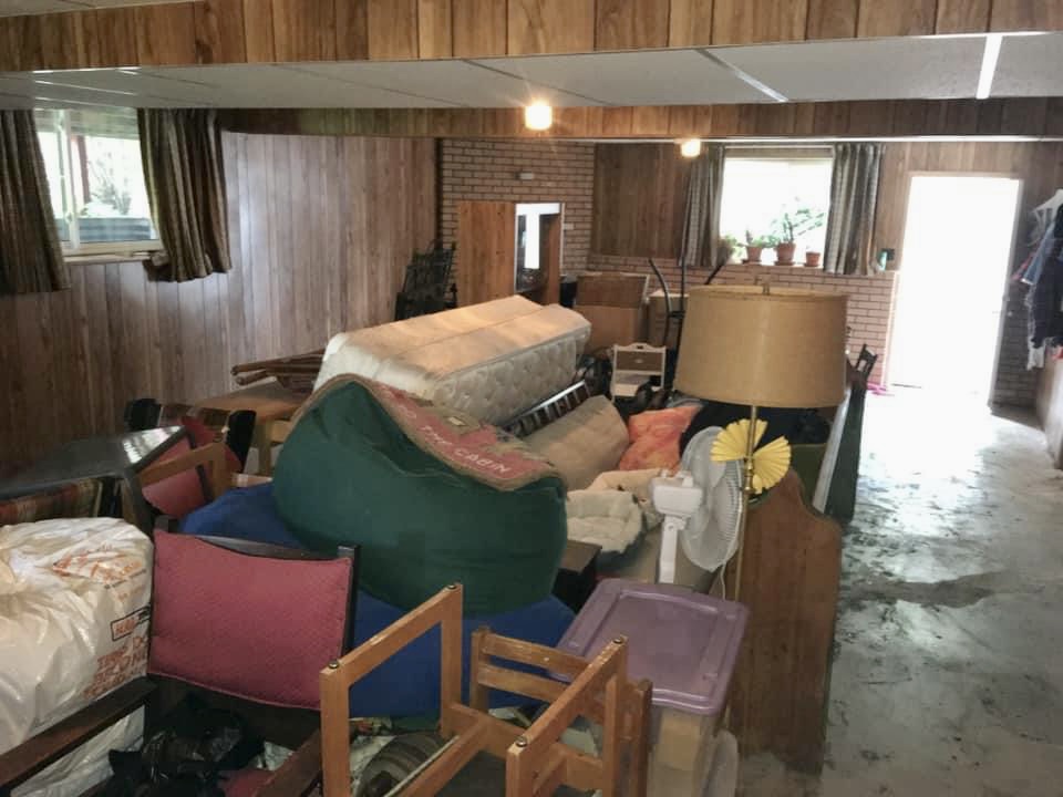 Before photo of a cluttered basement