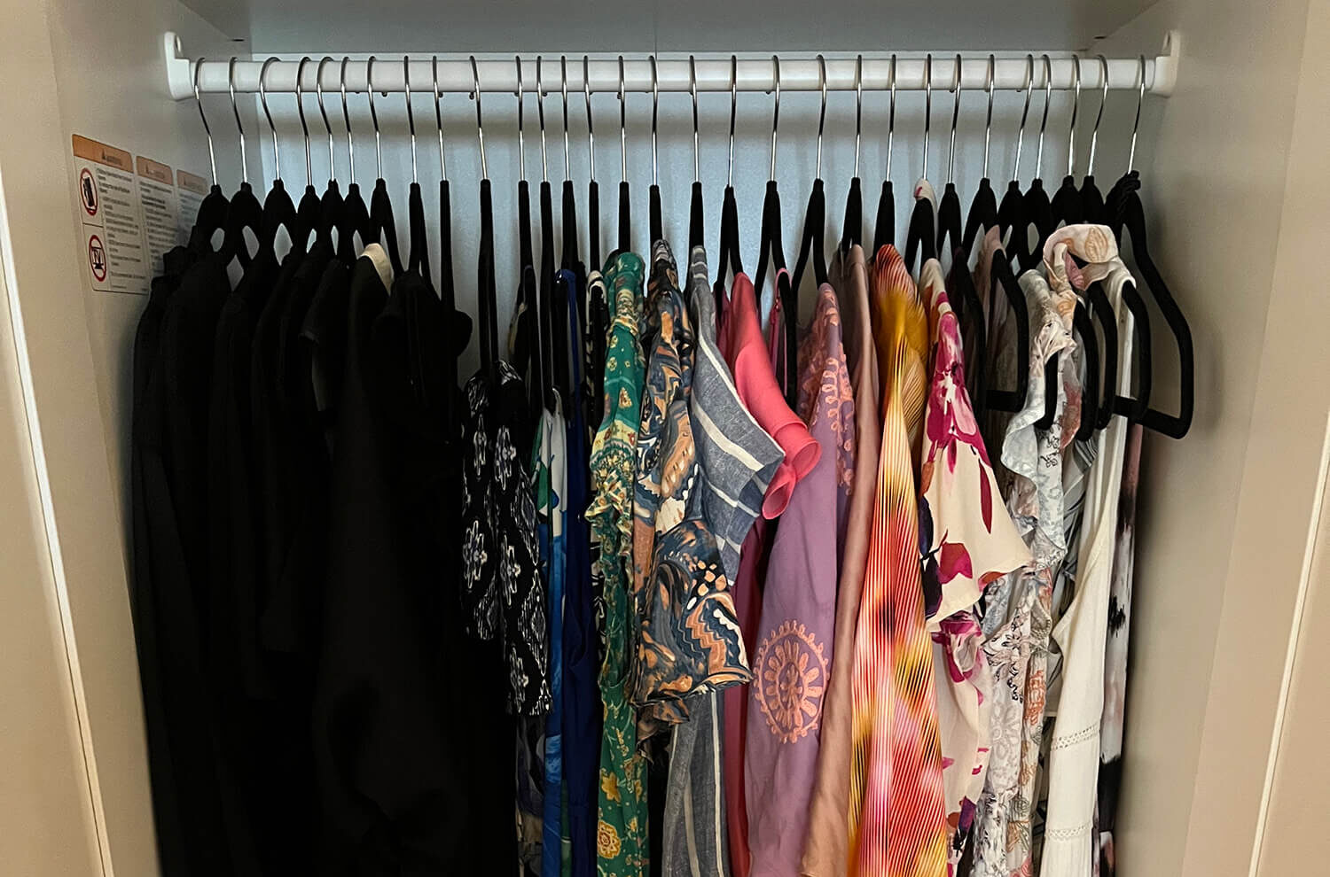 Closet Woman's wardrobe hanging on hangers in an organized closet
